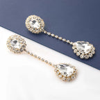 Gold chandelier earrings with cascading multi-layered drop design and polished gold-tone finish