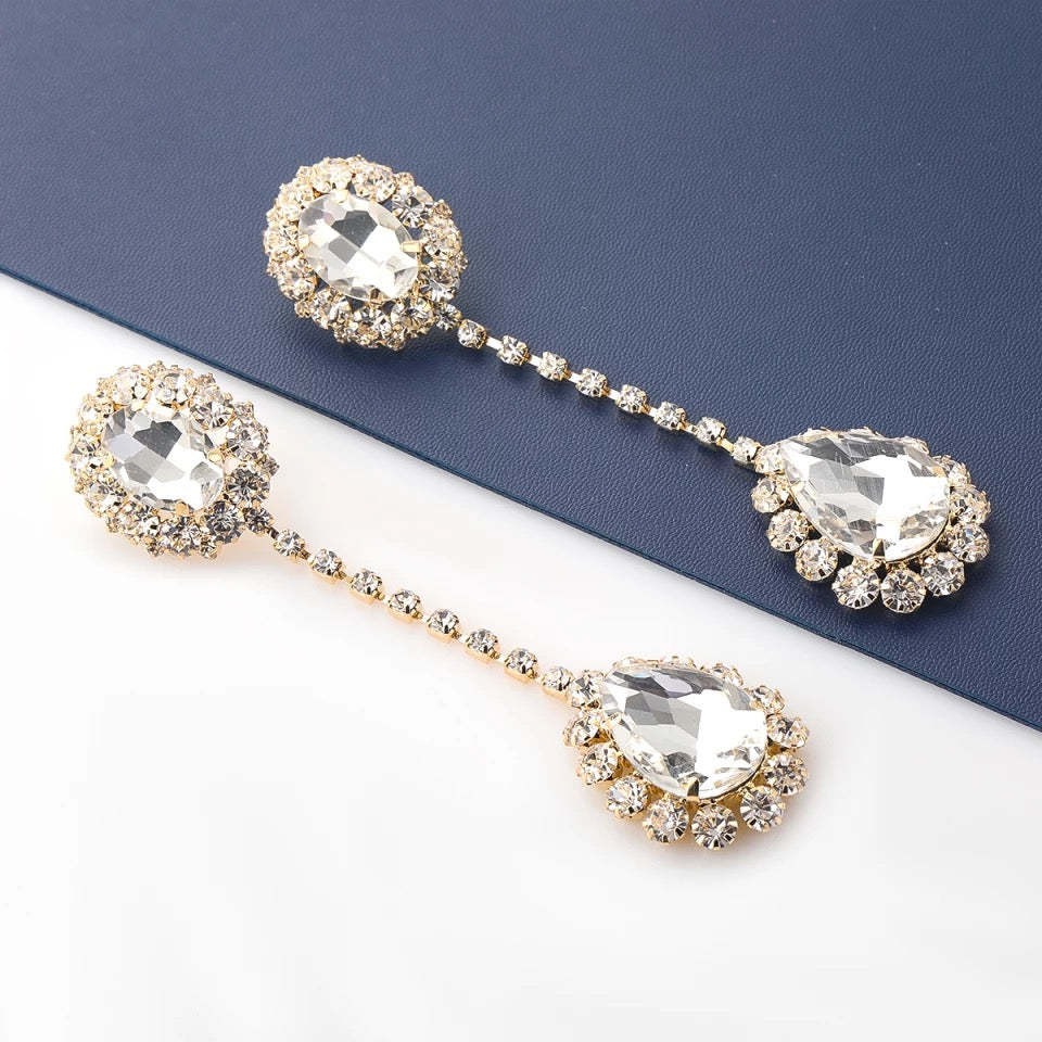 Gold chandelier earrings with cascading multi-layered drop design and polished gold-tone finish